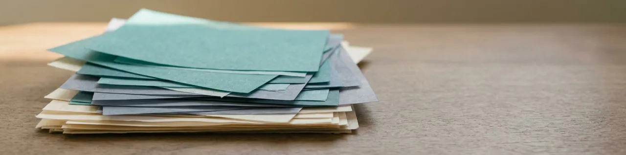 Abstract layered translucent rectangles in teal, slate, and cream, suggesting stacked documents — banner for NotebookLM strategy article